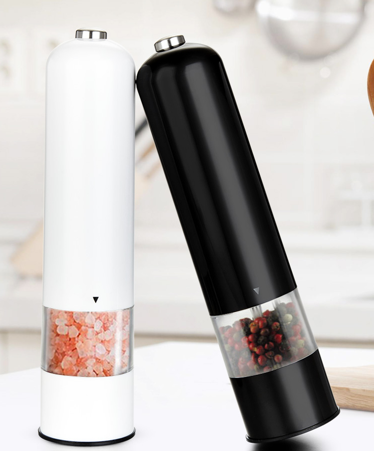 Black and white electric pepper mills on a light background