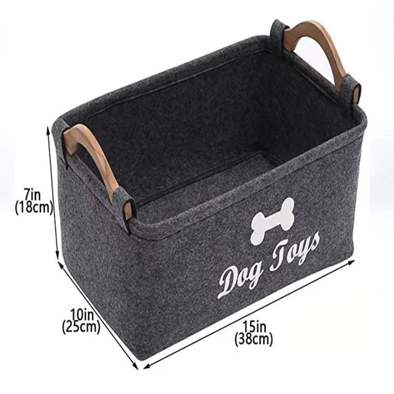 Gray storage bin with wooden handles labeled 'Dog Toys' and dimensions on a white background