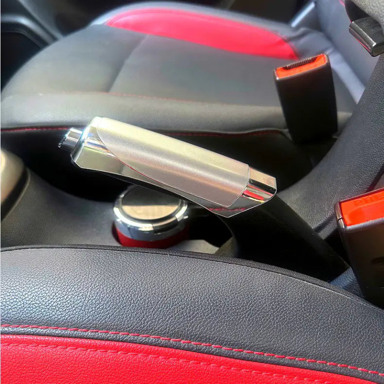 Close-up of a car's interior door handle and panel with red and black accents.
