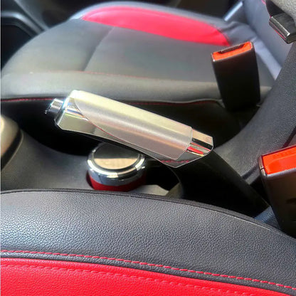Close-up of a car's interior door handle and panel with red and black accents.
