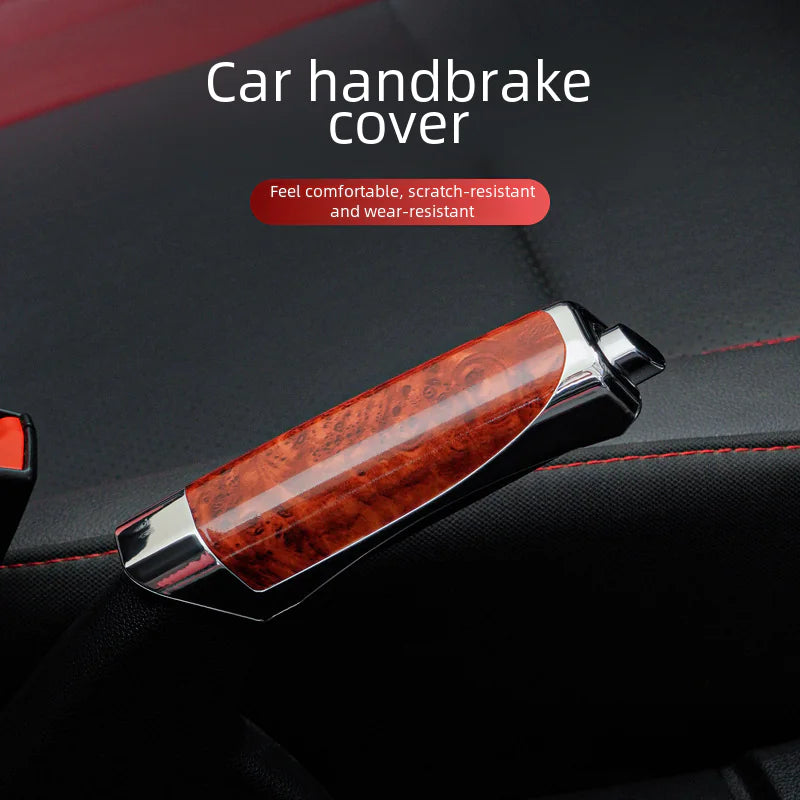 Car handbrake cover with wooden texture and metallic finish on a dark car interior background.