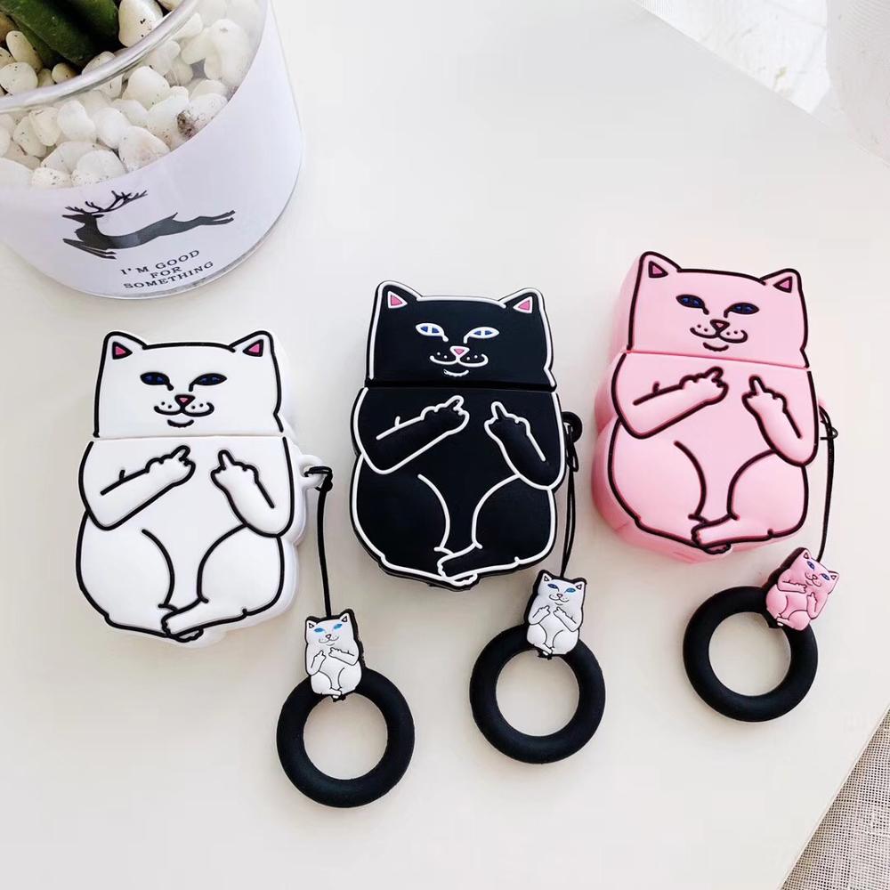 Three cat-themed air pod cases in black, white, and pink on a light surface.