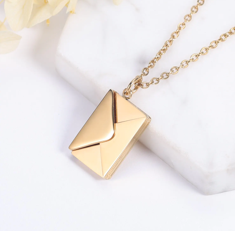 Gold geometric pendant necklace on a white background