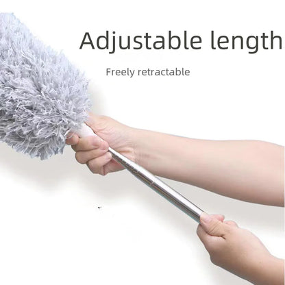 Hand holding a duster with an adjustable length on a white background