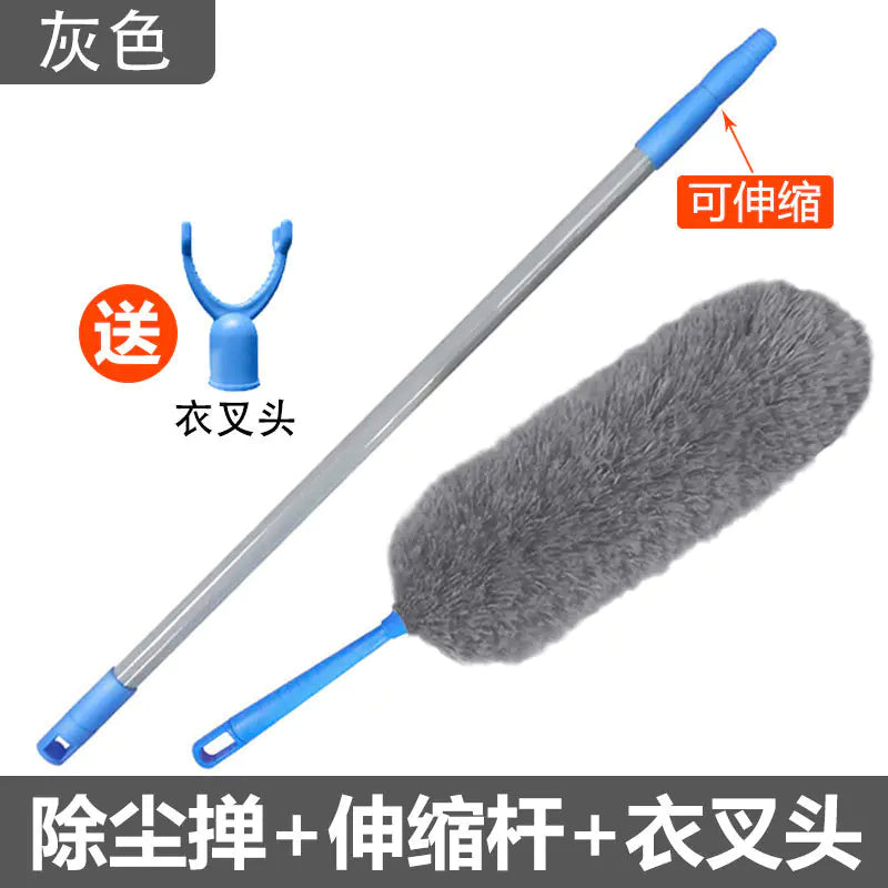 Cleaning tool with extendable handle and gray brush head on a white background