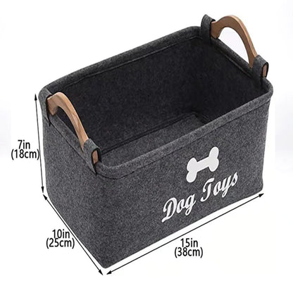 Gray storage bin with wooden handles labeled 'Dog Toys' and dimensions on a white background