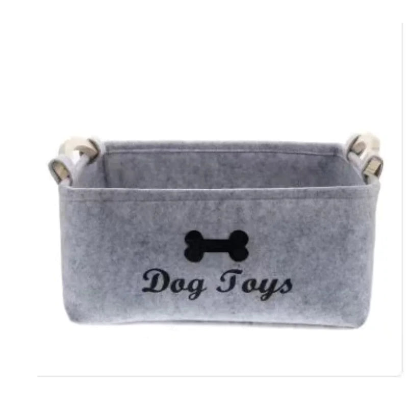 Gray pet toy storage basket with 'Dog Toys' text and bone icon on a white background