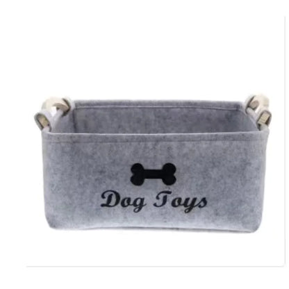 Gray pet toy storage basket with 'Dog Toys' text and bone icon on a white background