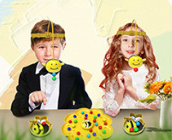 Two children wearing bee-themed headbands with colorful decorations on a light background.