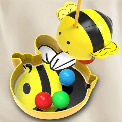Toy bee with colorful spheres on a beige background