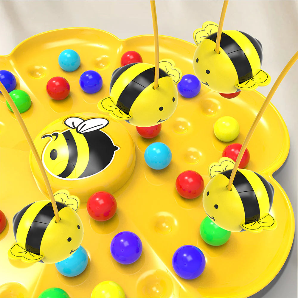 Colorful bee-themed fishing game with yellow tray, colorful balls, and bee figures on sticks.