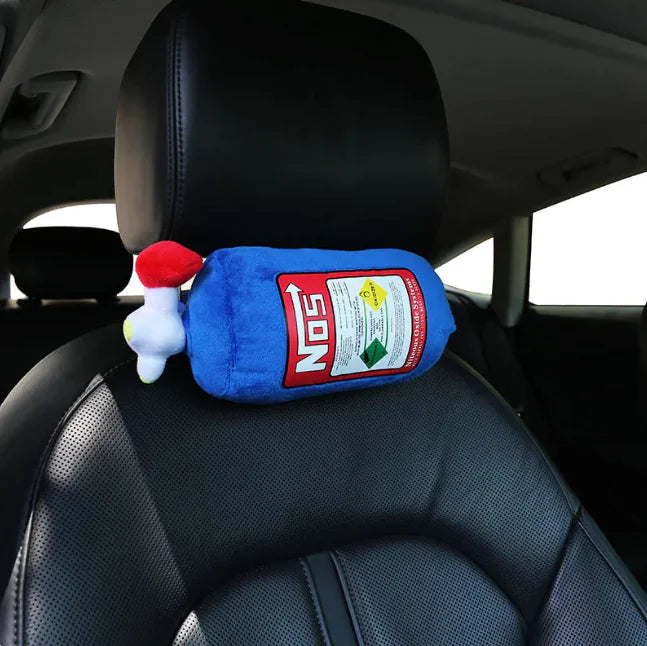 Plush toy resembling a bottle of NO'S hot sauce on a car seat