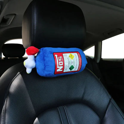 Plush toy resembling a bottle of NO'S hot sauce on a car seat