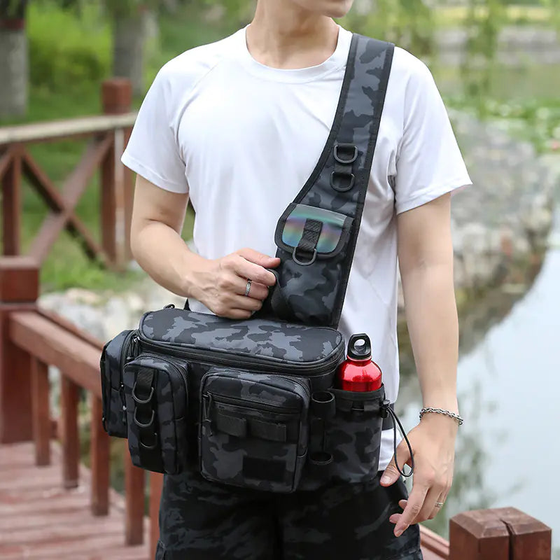 Person holding a black camouflage crossbody bag outdoors