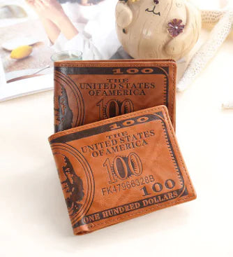 Two brown leather wallets with dollar bill design on a white surface.