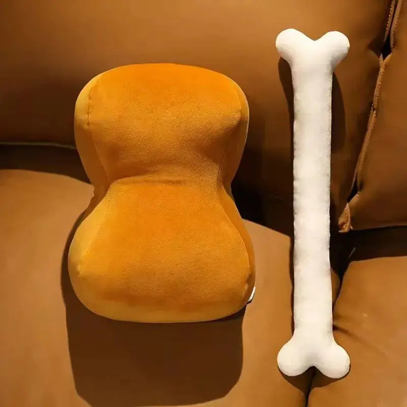 Orange plush toy resembling a dog bed and a white bone-shaped toy on a brown surface.