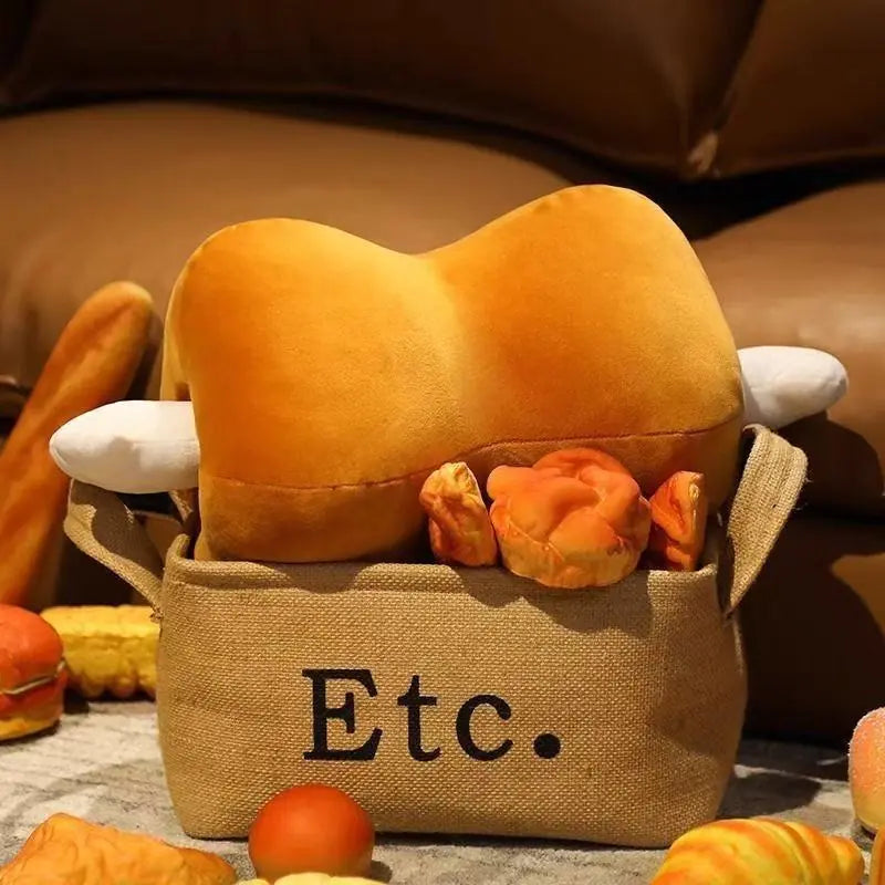 Plush bread toy with a bag labeled 'Etc.' on a soft surface.