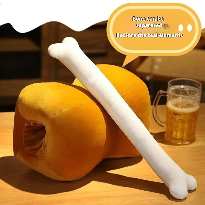 Yellow plush toy resembling a dog with a white bone on a wooden table, next to a glass of beer.