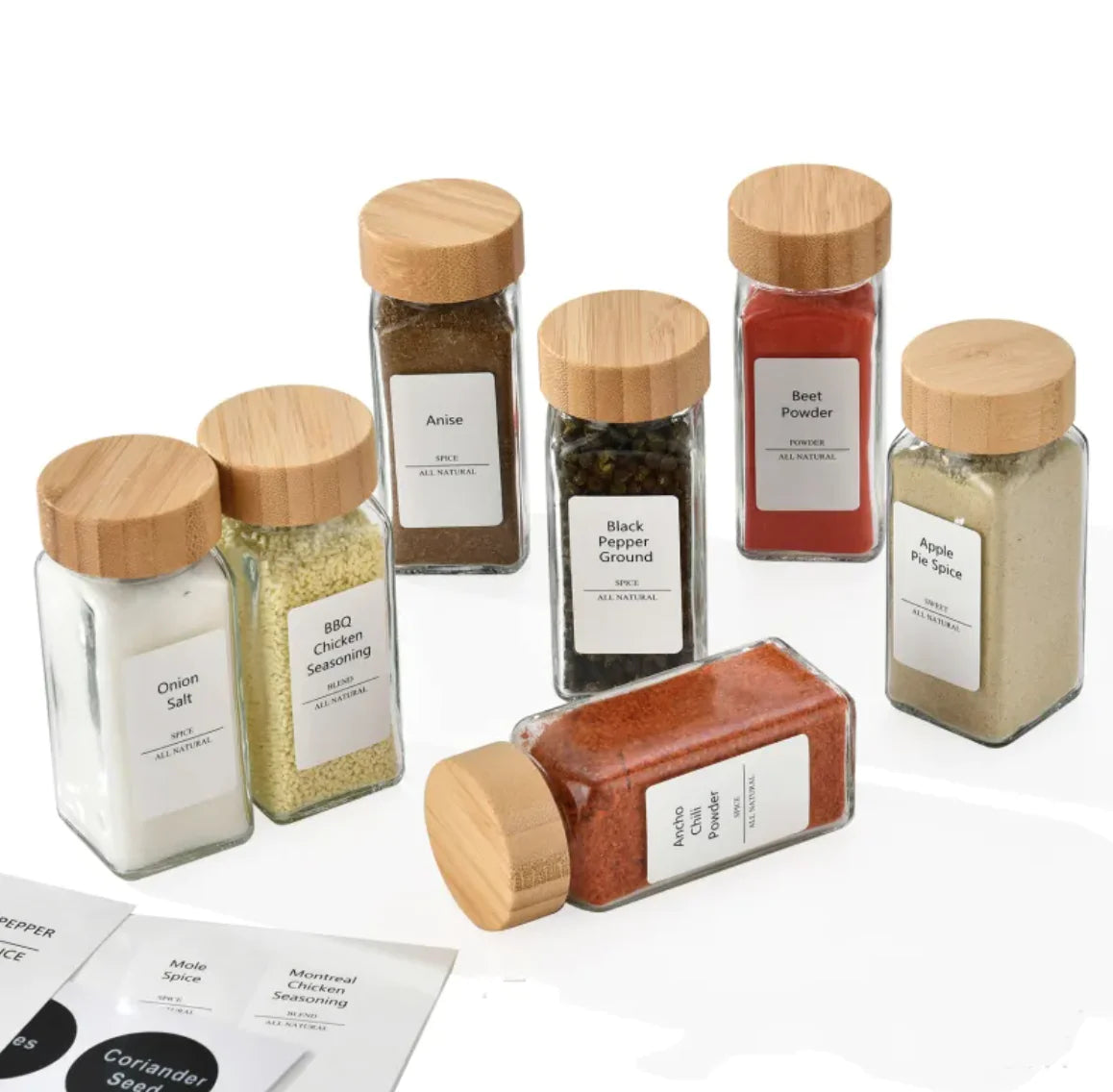 Set of spice jars with wooden lids on a white background