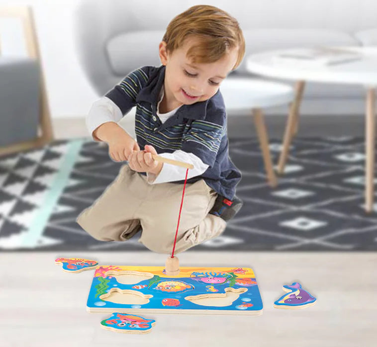 Child playing with a colorful magnetic fishing game on a carpeted floor.